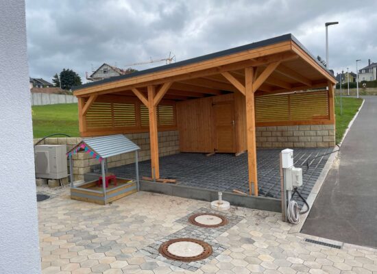 Seitenansicht mit geschlossener Wand und Geräteraum, Holz imprägniert, harmonische Linienführung. Die Struktur vermittelt Schutz, Ruhe und Dauerhaftigkeit.