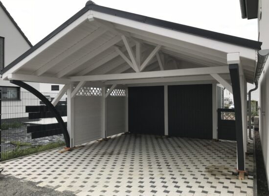 Satteldach Doppelcarport Vivaldi in Weiß mit anthrazitfarbenen Bögen und Blende. Die klare Linienführung und der Farbkontrast verleihen der Konstruktion Eleganz und Ausdruck.